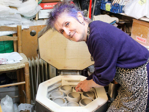 lesley mcshea taking mugs out of the kiln