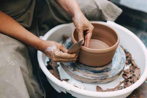 potter throwing clay