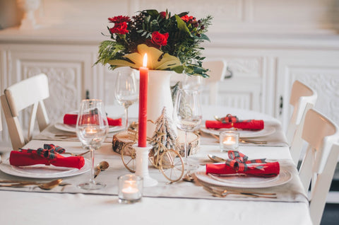 Christmas table with roses red napkins and candles