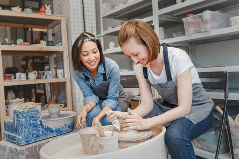two girls making pottery at a pottery class