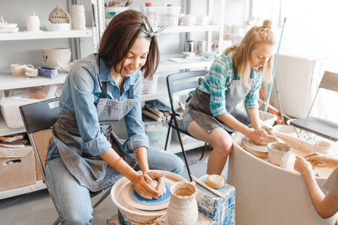 TWO WOMEN AT A POTTERY CLASS