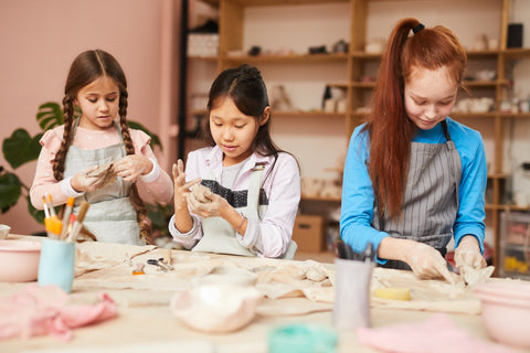 children making pottery in pottery class