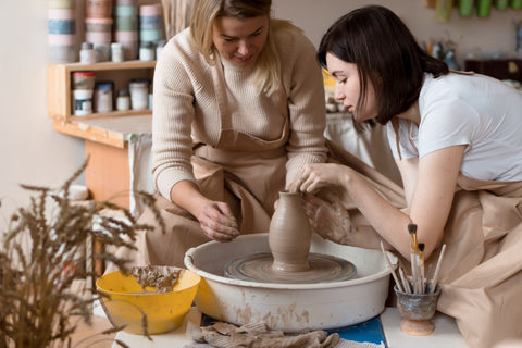potters making a vase on the wheel