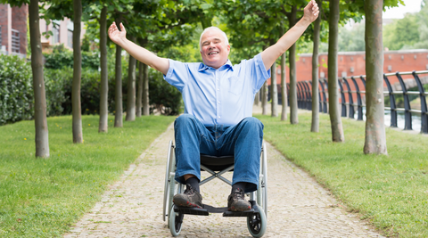 A happy man sat in his lightweight wheelchair.
