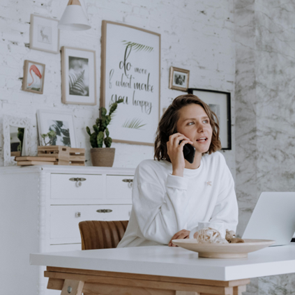 women sitting in home office on a phone call