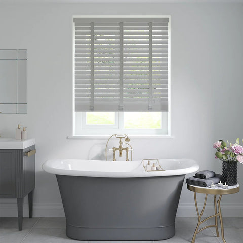 Silver grey wooden blind with tapes in a bathroom above the bath