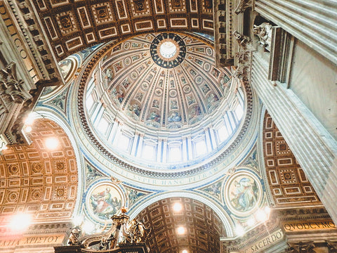 looking up at beautiful artwork in the dome of the St. Peter's Basilica
