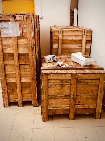 Wooden crates with coffee roasting machine inside