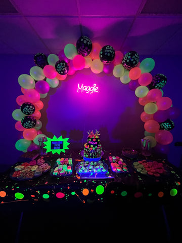 Glow Party Dessert Table with Custom Neon Sign, Neon Glow Balloons, and Glow in the Dark Foods