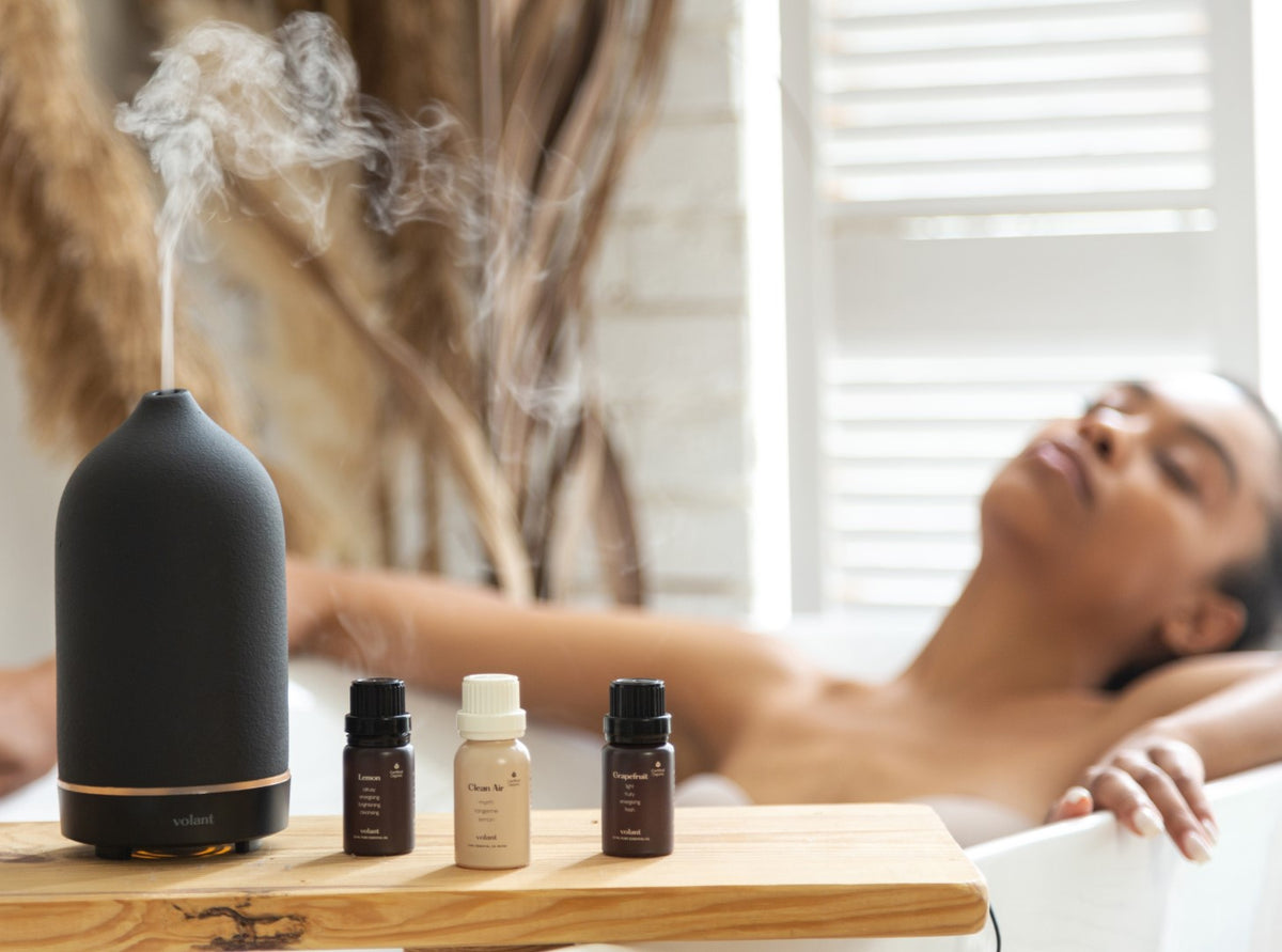 woman enjoying aromatherapy bath in the tub using lemon essential oil