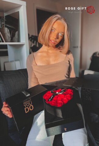 blonde woman open a handmade rose gift box