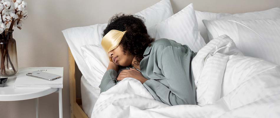 Woman sleeping with an eye mask on
