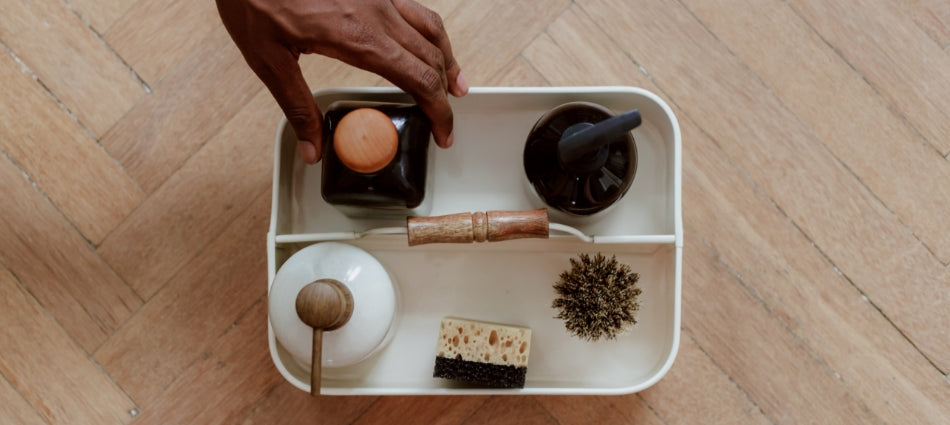 A small white caddy with bath products and sponges.