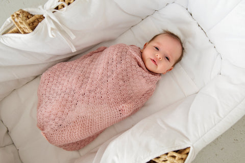 Baby in a merino swaddle