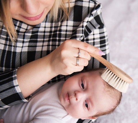 Mam brushing baby's hair