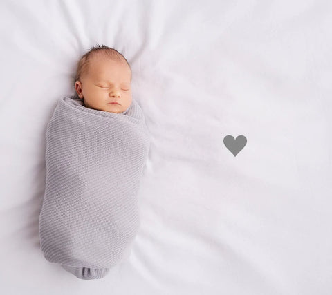 Baby in a grey bamboo swaddle