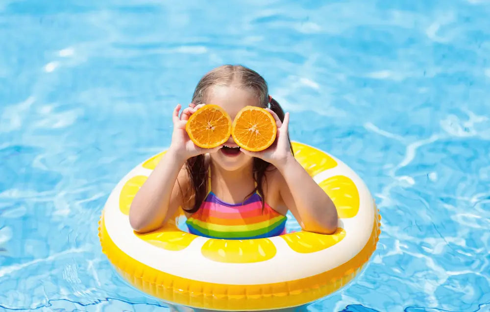 Child in pool with float