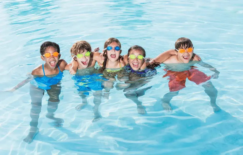 Children in above ground pool with goggles