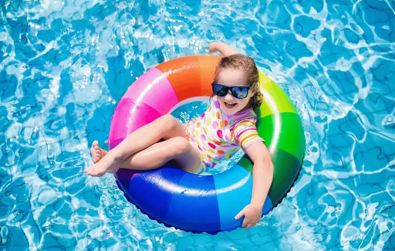 kid in pool with float