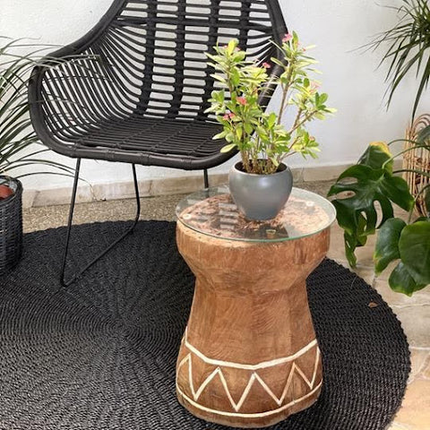 Coffee table with a teakwood base and glass top