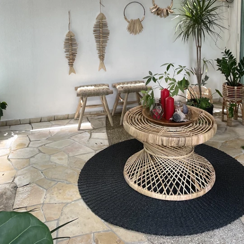 A full view of the String Coffee Table with a plant and candle decor