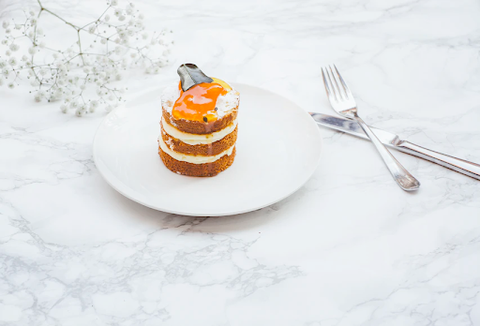 A marble table with dessert and utensils on it