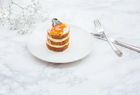 A marble table with dessert and utensils on it