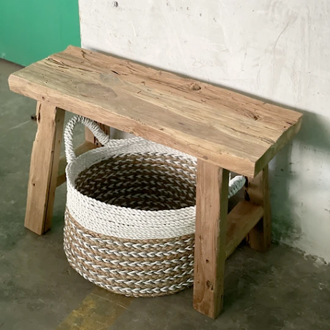 A Rustic Small Bench with a basket underneath