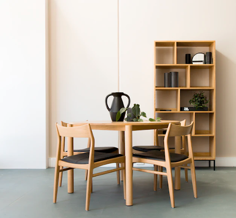 A wooden round table with chairs