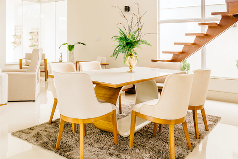 A white dining table with chairs