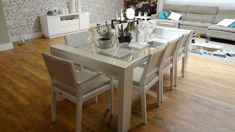 A glass table and chairs with beige outlines