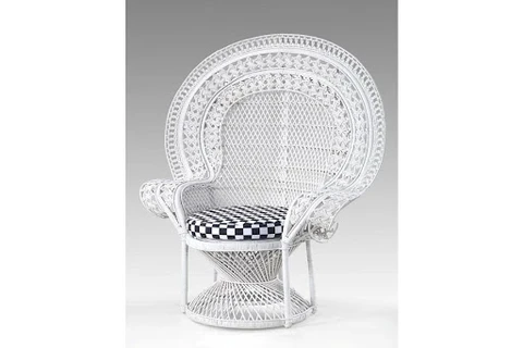 A white rattan chair with a black-and-white checkered seat