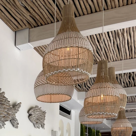 Big rattan lamps with white woven accents hanging from the ceiling