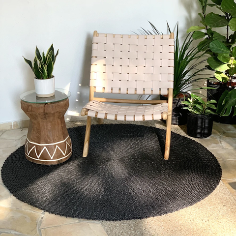 A Round Carpet placed underneath a chair and table