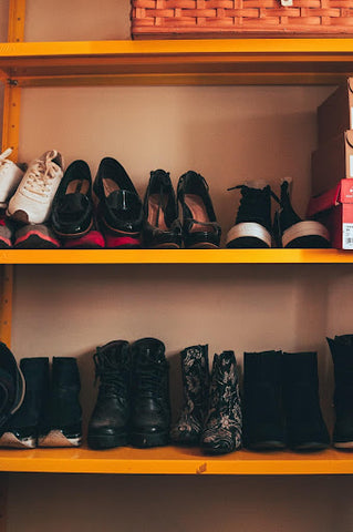 Different pairs of shoes on shelves