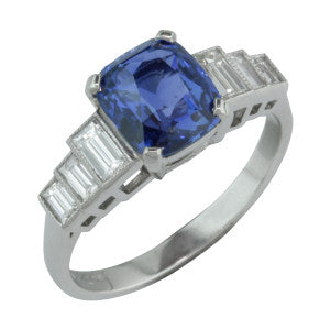 Bespoke vintage style sapphire ring set with 2.35 carat blue sapphire with side baguette diamonds