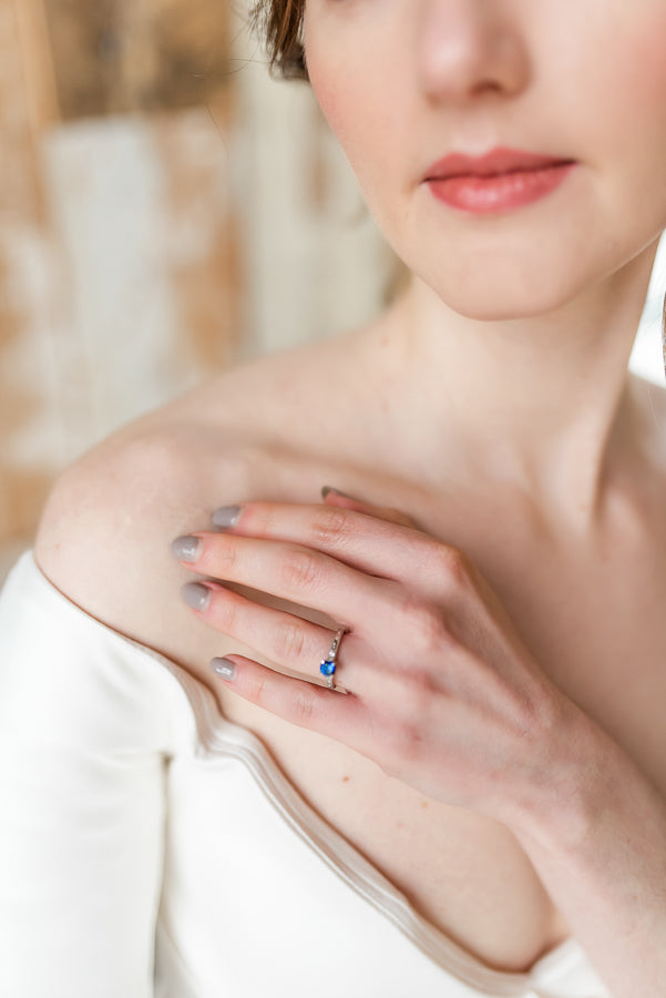 Antique sapphire and diamond engagement ring on hand