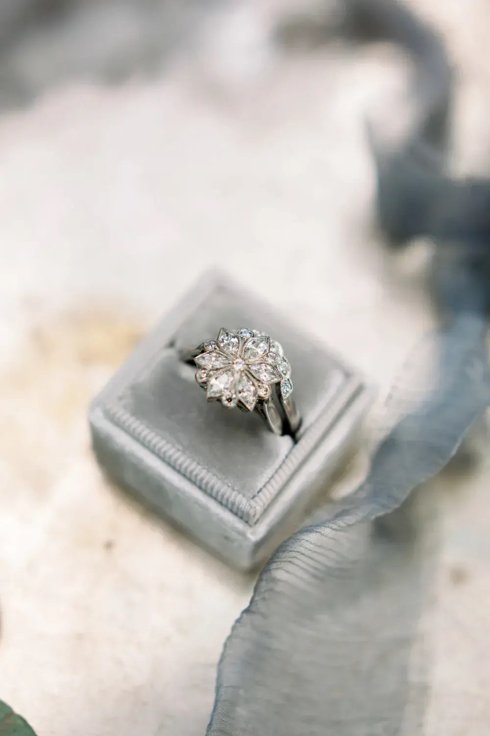 Curved diamond wedding band shaped around Edwardian marquise diamond ring