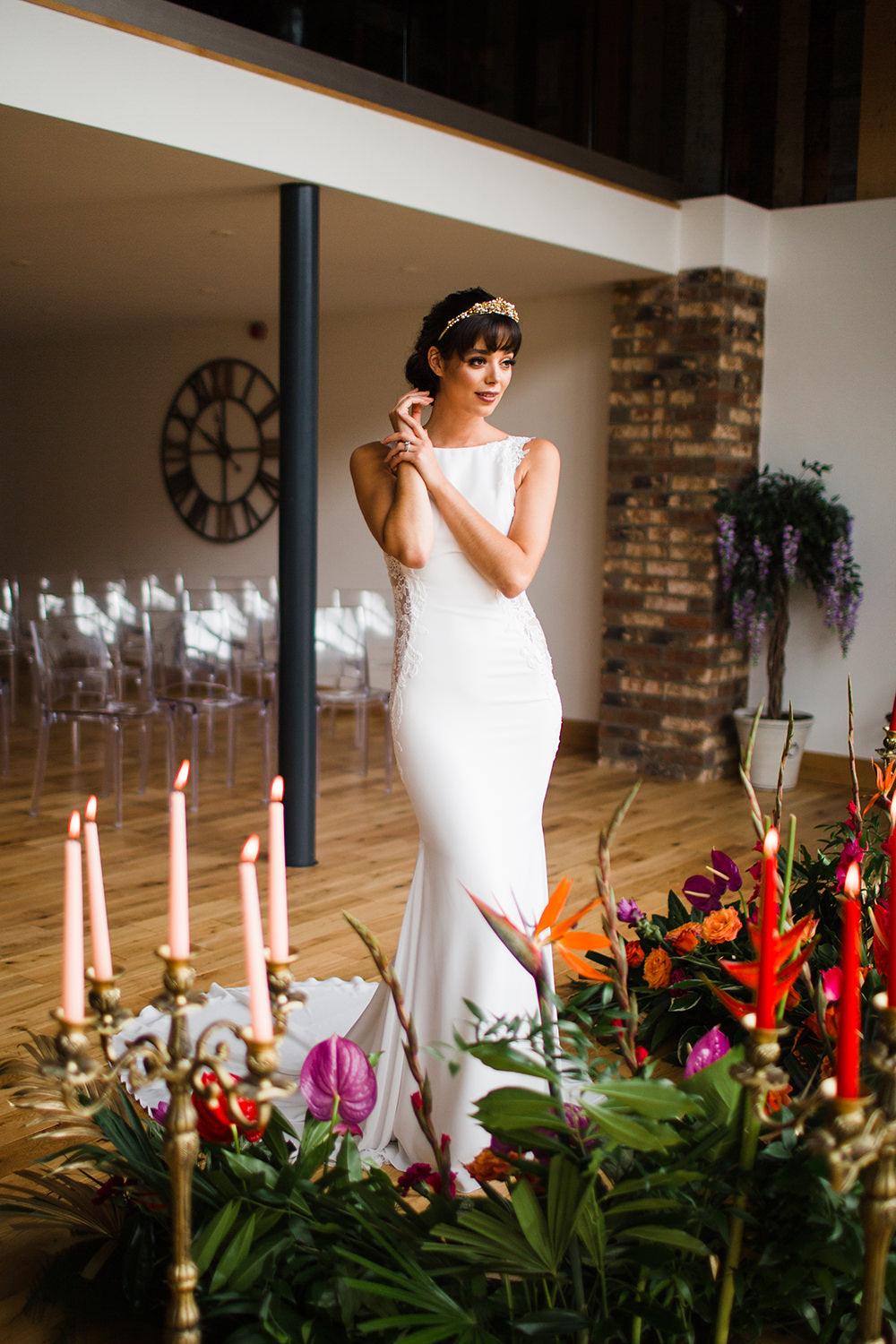 Bride with flowers and candles in wedding seating gallery