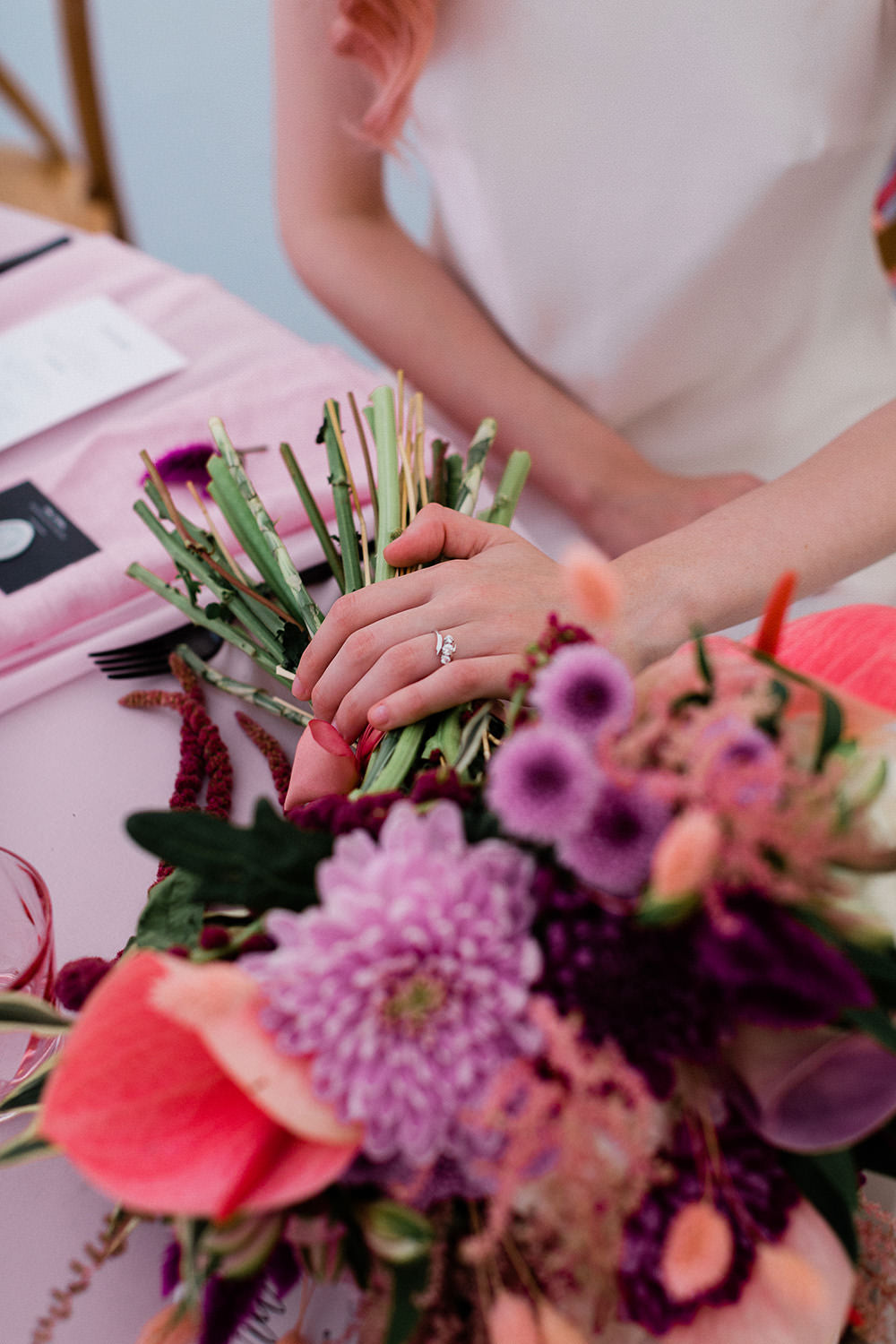 Unusual diamond twist wedding ring amongst floral bouquet