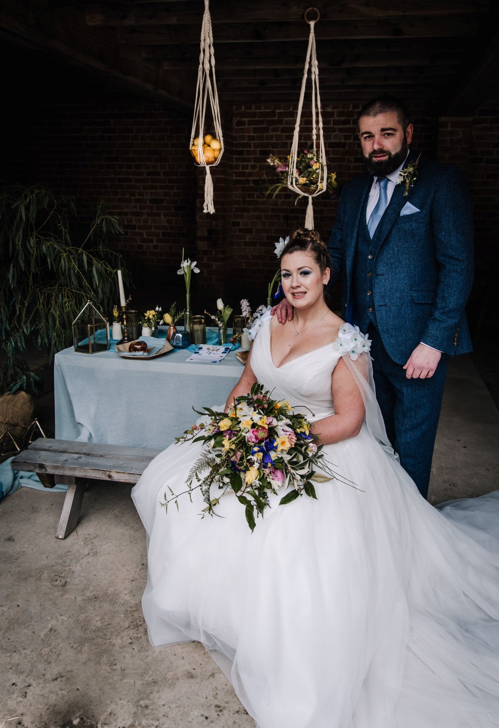 Bride and groom at wedding table in stable barn