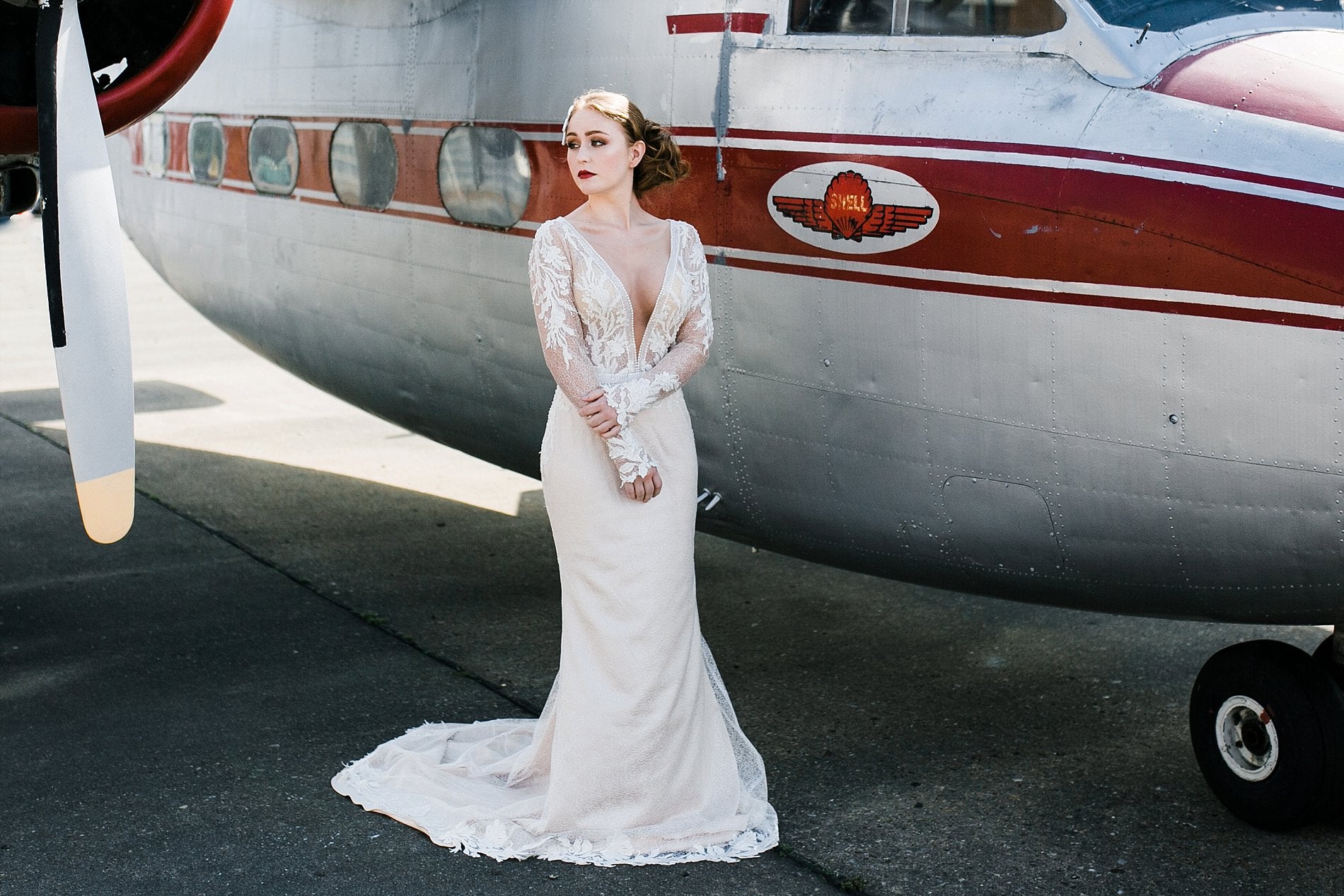 Bride outside vintage aircraft