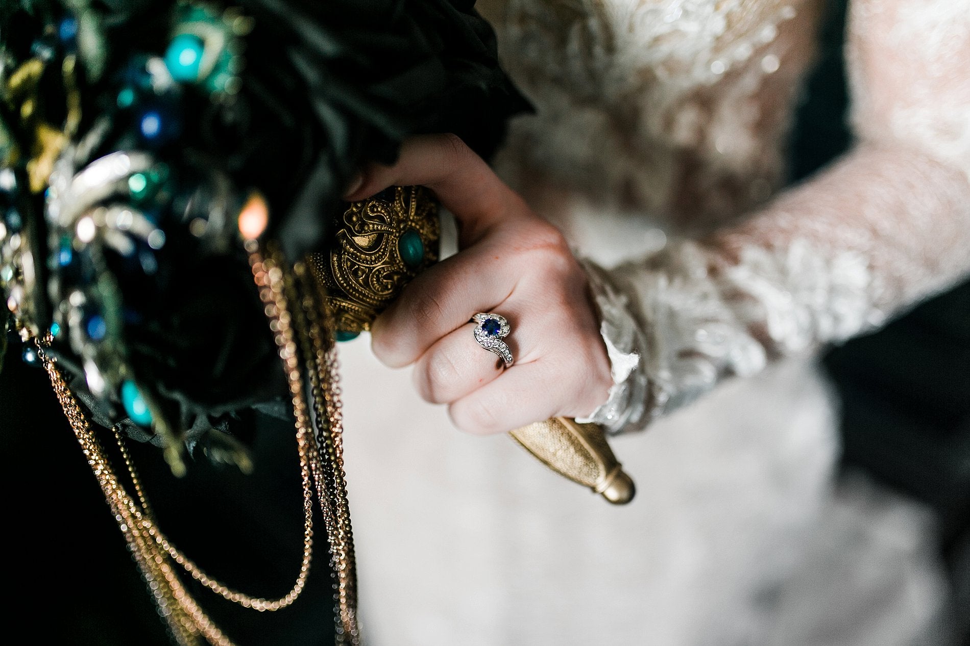 Blue sapphire engagement ring with diamond swirls