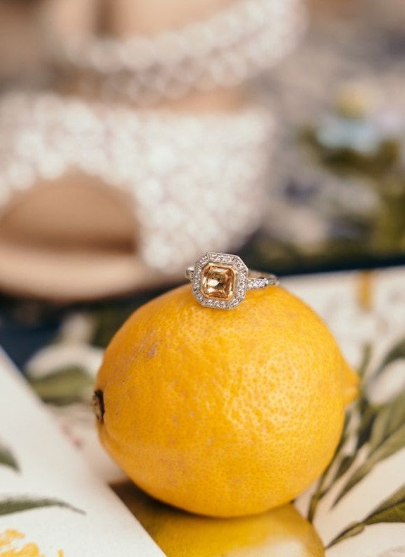 Yellow sapphire halo engagement ring with diamonds