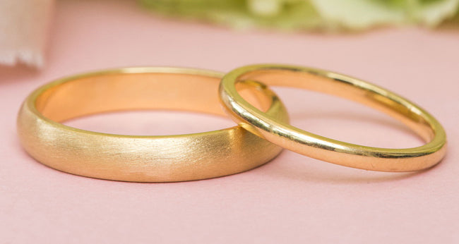 men's yellow gold brushed wedding ring with matching yellow gold women's plain wedding band