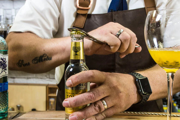 bartender using the EndoBlade™ bottle opener