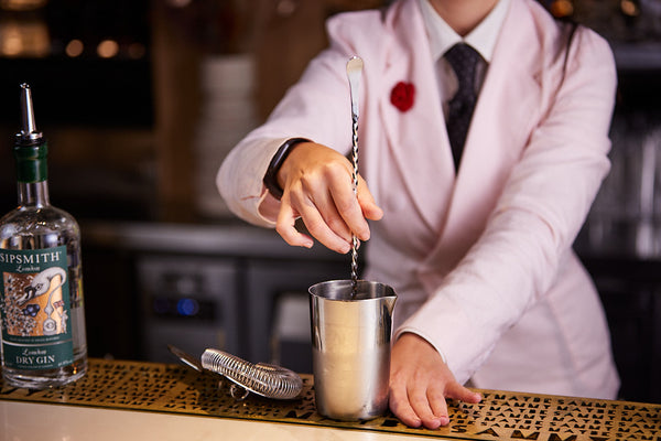 bartender using a ProPaddle stirrer to mix a cocktail drink