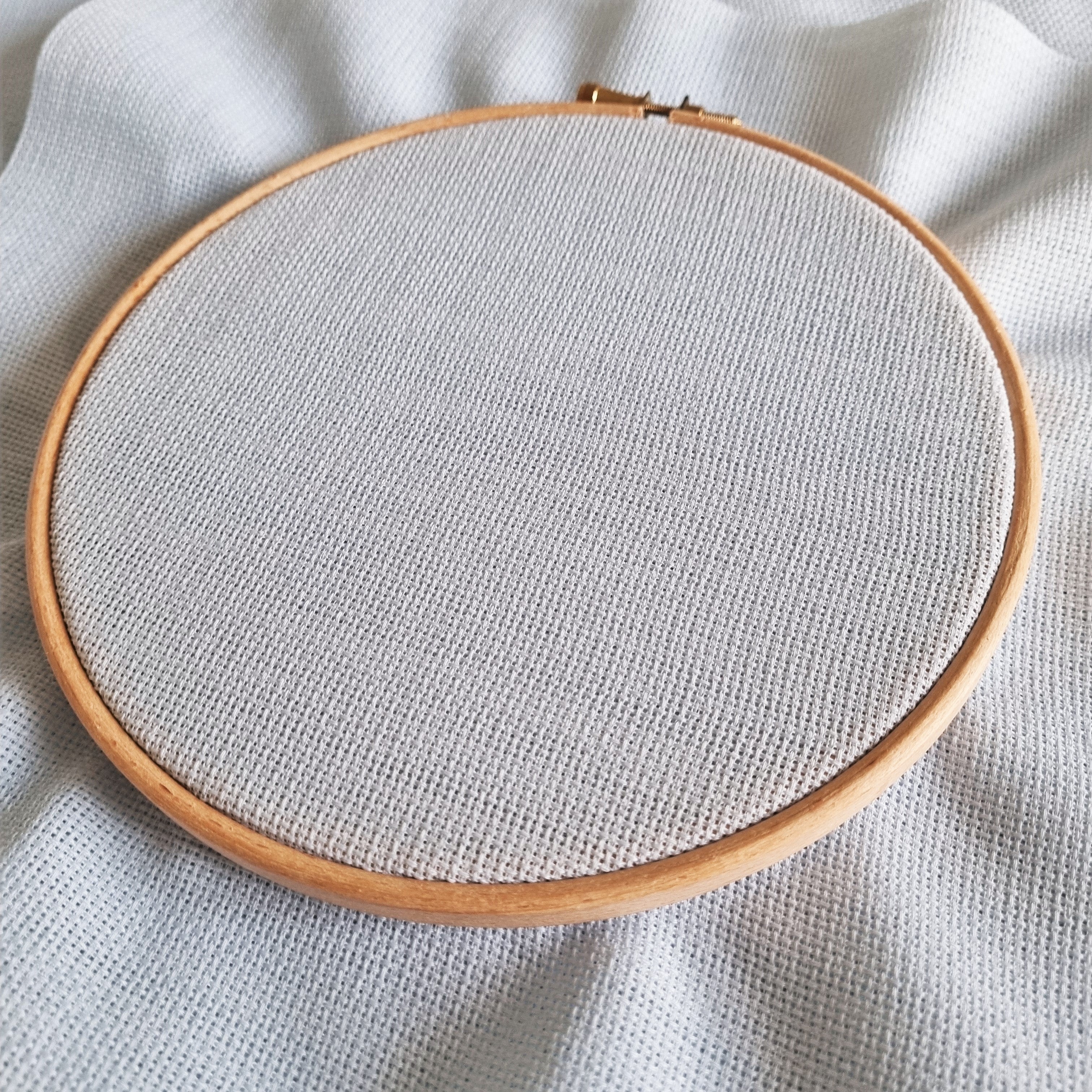 Aida fabric in an embroidery hoop
