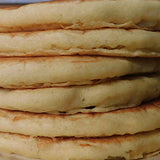 A tall stack of fresh pancakes, light and fluffy