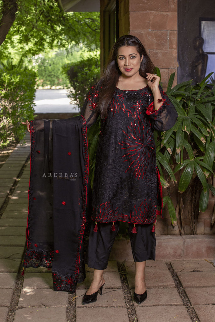 Black chiffon shirt heavily red sequence work with tassels on both sleeves and daman.  Matching inner lining  Dupatta with four corners and centre embroidered and tassels  Matching colour trouser with embroidery.  unique 3pc suit to compliment party wear and weddings